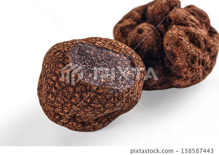 Whole black winter truffle isolated on a white background. Gourmet culinary ingredient. Whole black winter truffle isolated on a white background. Gourmet culinary ingredient. 138587443