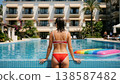 Woman Relaxing in Luxury Resort Infinity Pool 138587482