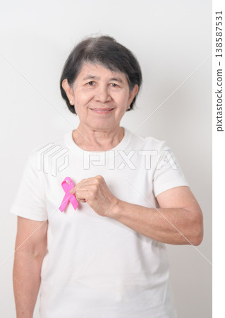 Elderly woman with pink Ribbon for Pink October Breast Cancer Awareness month, May Women Health, August World Breastfeeding week, Nursing Mothers, Pregnancy and Infant Loss Remembrance, Stillbirth Elderly woman with pink Ribbon for Pink October Breast Cancer Awareness month, May Women Health, August World Breastfeeding week, Nursing Mothers, Pregnancy and Infant Loss Remembrance, Stillbirth 138587531