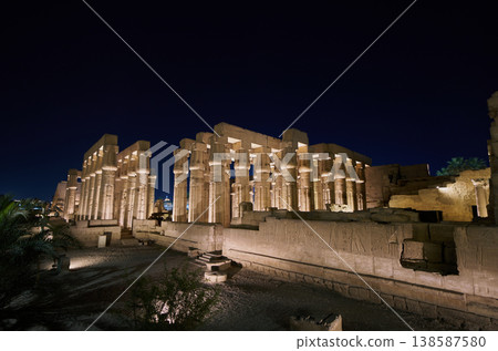 Luxor Temple at night—Ancient Egyptian colonnades illuminated by lights Luxor Temple at night—Ancient Egyptian colonnades illuminated by lights 138587580