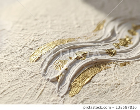A background with a textured surface reminiscent of Japanese washi paper, adorned with white, three-dimensional wave patterns and gold leaf. 138587816