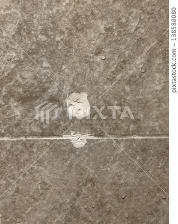 Damaged Porcelain Tile Surface With White Plaster Repair Mark Damaged Porcelain Tile Surface With White Plaster Repair Mark 138588080