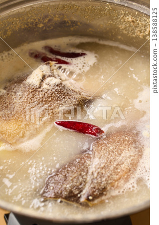 Parboil the bamboo shoots in rice bran. Parboil the bamboo shoots in rice bran. 138588125