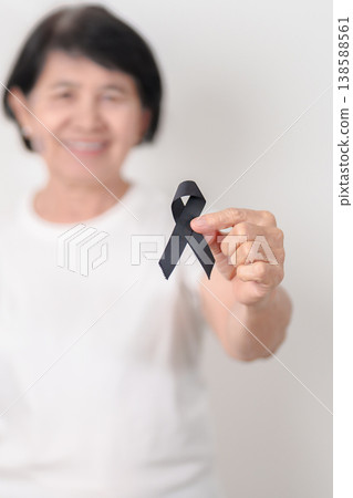 Elderly with Black ribbon for May Melanoma and skin cancer Awareness month, October Vaccine injury awareness month, Mourning Remembrance, March Sleep awareness week, Gang Prevention and Anti Violence Elderly with Black ribbon for May Melanoma and skin cancer Awareness month, October Vaccine injury awareness month, Mourning Remembrance, March Sleep awareness week, Gang Prevention and Anti Violence 138588561