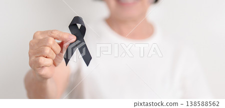 Elderly with Black ribbon for May Melanoma and skin cancer Awareness month, October Vaccine injury awareness month, Mourning Remembrance, March Sleep awareness week, Gang Prevention and Anti Violence Elderly with Black ribbon for May Melanoma and skin cancer Awareness month, October Vaccine injury awareness month, Mourning Remembrance, March Sleep awareness week, Gang Prevention and Anti Violence 138588562