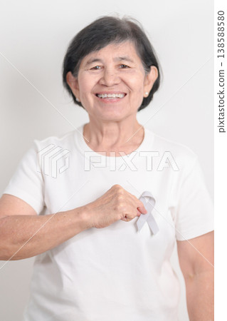 Elderly with Gray ribbon for May Brain Cancer Awareness month and Asthma Awareness, Support life people Survivor. Healthcare and February World cancer day 138588580