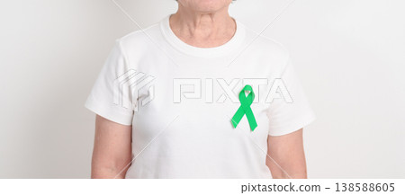 Elderly with Green Ribbon for concept of April Donate Life month, Organ Donation and Transplant Awareness, May Mental Health Awareness month and October Liver cancer. Health and world cancer day Elderly with Green Ribbon for concept of April Donate Life month, Organ Donation and Transplant Awareness, May Mental Health Awareness month and October Liver cancer. Health and world cancer day 138588605