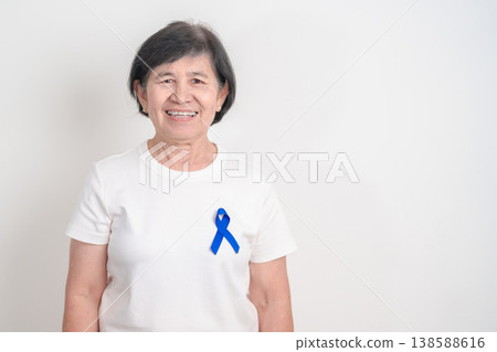 Elderly with dark Blue or Navy blue Ribbon for concept of March Colorectal and Colon Cancer Awareness month, May Arthritis awareness, July Juvenile arthritis and Childhood. Health and world cancer day Elderly with dark Blue or Navy blue Ribbon for concept of March Colorectal and Colon Cancer Awareness month, May Arthritis awareness, July Juvenile arthritis and Childhood. Health and world cancer day 138588616