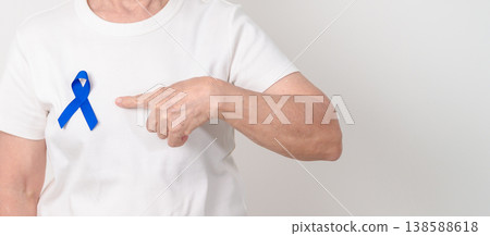Elderly with dark Blue or Navy blue Ribbon for concept of March Colorectal and Colon Cancer Awareness month, May Arthritis awareness, July Juvenile arthritis and Childhood. Health and world cancer day 138588618