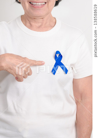Elderly with dark Blue or Navy blue Ribbon for concept of March Colorectal and Colon Cancer Awareness month, May Arthritis awareness, July Juvenile arthritis and Childhood. Health and world cancer day 138588619