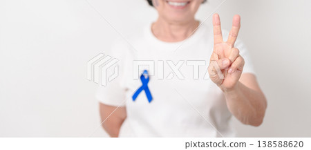 Elderly with dark Blue or Navy blue Ribbon for concept of March Colorectal and Colon Cancer Awareness month, May Arthritis awareness, July Juvenile arthritis and Childhood. Health and world cancer day 138588620