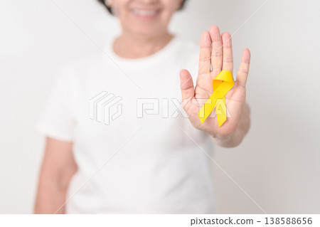 Elderly with Yellow Ribbon for concept of yellow September, Suicide prevention day, Childhood, Pediatric, May Missing Children Awareness day month, support survivor. Healthcare and World Cancer day 138588656