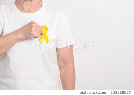 Elderly with Yellow Ribbon for concept of yellow September, Suicide prevention day, Childhood, Pediatric, May Missing Children Awareness day month, support survivor. Healthcare and World Cancer day 138588657