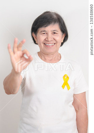Elderly with Yellow Ribbon for concept of yellow September, Suicide prevention day, Childhood, Pediatric, May Missing Children Awareness day month, support survivor. Healthcare and World Cancer day Elderly with Yellow Ribbon for concept of yellow September, Suicide prevention day, Childhood, Pediatric, May Missing Children Awareness day month, support survivor. Healthcare and World Cancer day 138588660