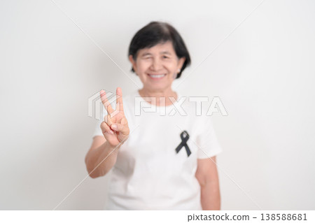 Elderly with Black ribbon for May Melanoma and skin cancer Awareness month, October Vaccine injury awareness month, Mourning Remembrance, March Sleep awareness week, Gang Prevention and Anti Violence Elderly with Black ribbon for May Melanoma and skin cancer Awareness month, October Vaccine injury awareness month, Mourning Remembrance, March Sleep awareness week, Gang Prevention and Anti Violence 138588681