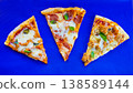 Pepperoni Pizza Slices on Blue Background Top View 138589144