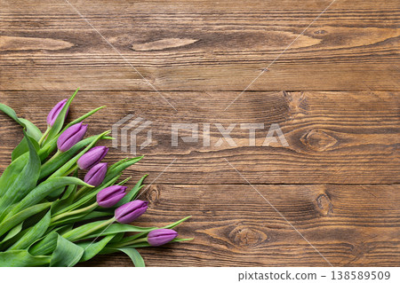 Purple tulips on rustic wooden background 138589509