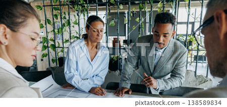 Engineers using tools to verify schematic accuracy and measurements Engineers using tools to verify schematic accuracy and measurements 138589834