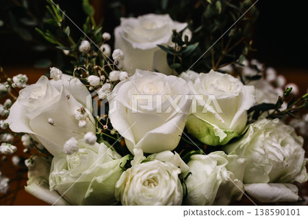 An elegant bouquet of white roses and baby's breath with green eucalyptus foliage. An elegant bouquet of white roses and baby's breath with green eucalyptus foliage. 138590101
