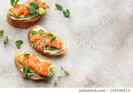 Savory salmon avocado bruschetta with microgreens and sesame seeds Savory salmon avocado bruschetta with microgreens and sesame seeds 138590413