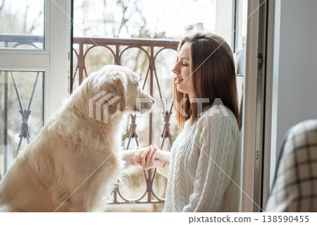 Woman and dog sharing a loving moment at home Woman and dog sharing a loving moment at home 138590455