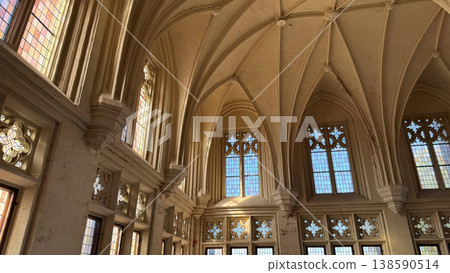 Large gothic hall with high vaulted ceiling tall windows and stone columns inside Malbork Castle Poland. Architecture, heritage and interior space concept 138590514