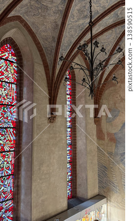 Gothic interior hall with ribbed vault ceiling stained glass windows and chandelier in Malbork Castle Poland. Architecture, history and heritage concept 138590515