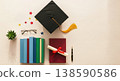 Flat lay of graduation cap, diploma with ribbon, books, glasses and pen on a light desk, symbolizing education, success and academic achievement. 138590586