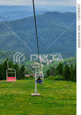 Open Chairlift Descending Mountain Slope Open Chairlift Descending Mountain Slope 138590857