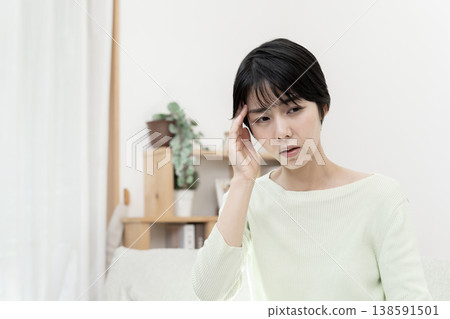 Young woman with a headache; headache; migraine. Young woman with a headache; headache; migraine. 138591501