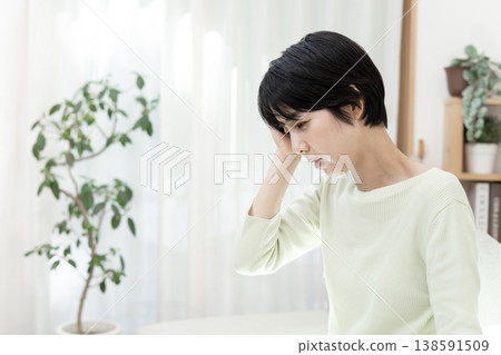 Young woman with a headache; headache; migraine. Young woman with a headache; headache; migraine. 138591509