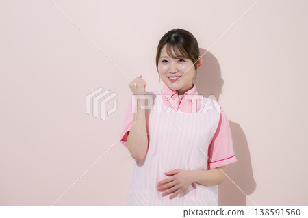 The image of a woman working as a caregiver or childcare worker in home care, with a pink background, represents the rewarding nature of her work. The image of a woman working as a caregiver or childcare worker in home care, with a pink background, represents the rewarding nature of her work. 138591560