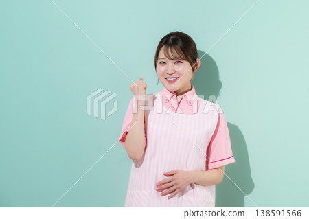 A green background image of a woman working as a caregiver or childcare worker, portraying the rewarding nature of her home care work, complete with a triumphant pose. A green background image of a woman working as a caregiver or childcare worker, portraying the rewarding nature of her home care work, complete with a triumphant pose. 138591566