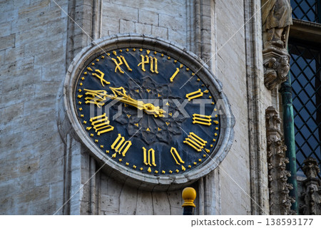Historic tower clock with gold roman numerals 138593177