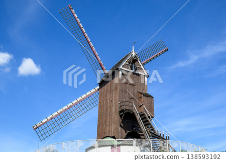 Traditional wooden windmill under blue sky 138593192
