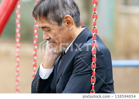 A troubled businessman in a park 138594054