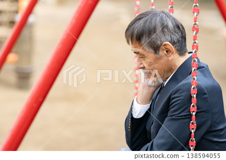 A troubled businessman in a park A troubled businessman in a park 138594055