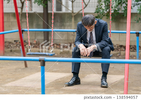 A troubled businessman in a park A troubled businessman in a park 138594057
