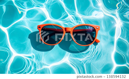 Sunglasses Floating on Blue Pool Water Sunglasses Floating on Blue Pool Water 138594132