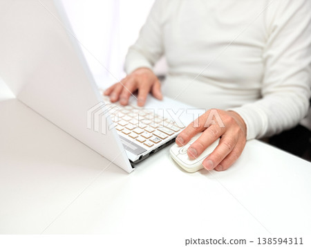 A man in his 30s or 40s who uses a computer at home. A man in his 30s or 40s who uses a computer at home. 138594311