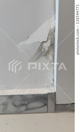 Cracked wall corner with visible damage and exposed white material, suitable for background 138594771