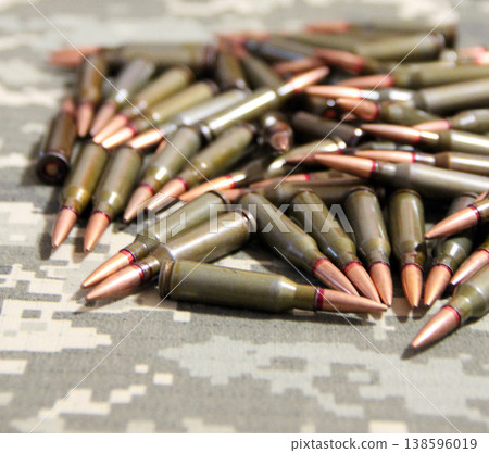 Cartridges for Kalashnikov assault rifle. War Concept. Heap of billets 138596019