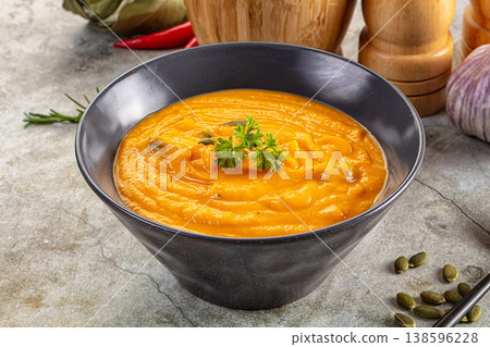 Tasty pumpkin cream soup served seeds 138596228