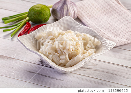 Cooked rice noodles in a white bowl with fresh lime, garlic, and chili peppers Cooked rice noodles in a white bowl with fresh lime, garlic, and chili peppers 138596425