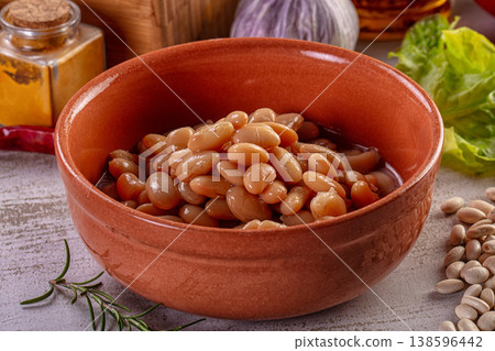 Cooked white beans in a terracotta bowl with fresh vegetables and spices. Cooked white beans in a terracotta bowl with fresh vegetables and spices. 138596442