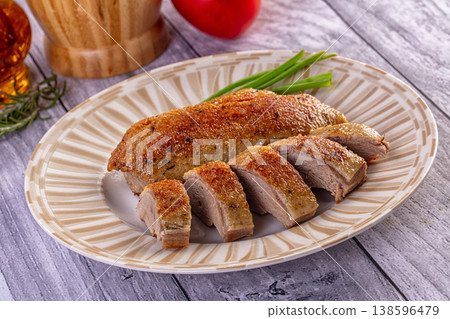 Appetizing sliced duck breast with golden crispy skin on a ceramic plate Appetizing sliced duck breast with golden crispy skin on a ceramic plate 138596479