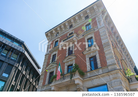 Old house wall facade streets in center Milan city. Windows balcony with flag Old house wall facade streets in center Milan city. Windows balcony with flag 138596507