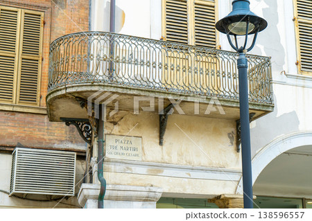 Italian round balcony with wrought iron grilles. Old architecture in the city of Rimini Italy. Piazza Tre Martiri Italian round balcony with wrought iron grilles. Old architecture in the city of Rimini Italy. Piazza Tre Martiri 138596557