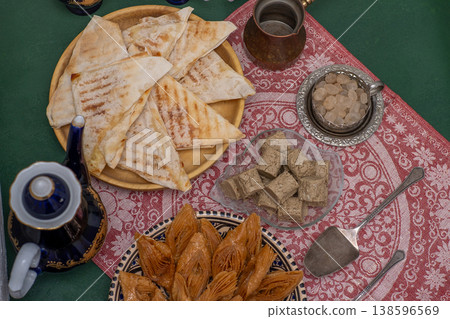 Oriental sweets and coffee on the table. Baklava, halva for dessert. Food and drink Oriental sweets and coffee on the table. Baklava, halva for dessert. Food and drink 138596569
