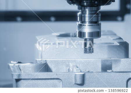 Heavy-duty CNC milling machine performing rough cutting on aluminum casting parts with a high-performance indexable tool. Heavy-duty CNC milling machine performing rough cutting on aluminum casting parts with a high-performance indexable tool. 138596922